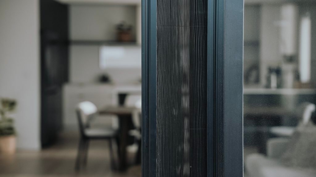 Black pleated flyscreen on a sliding door in Halswell